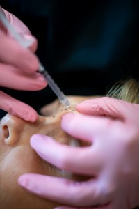 Doctor performing injection treatment